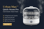 White Urban Max™ Quick-Steam Pro electric egg cooker with dual-layer capacity, steam vents, and a power button on a dark background.